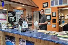 Hot tub showroom with sales staff assisting customer at display counter