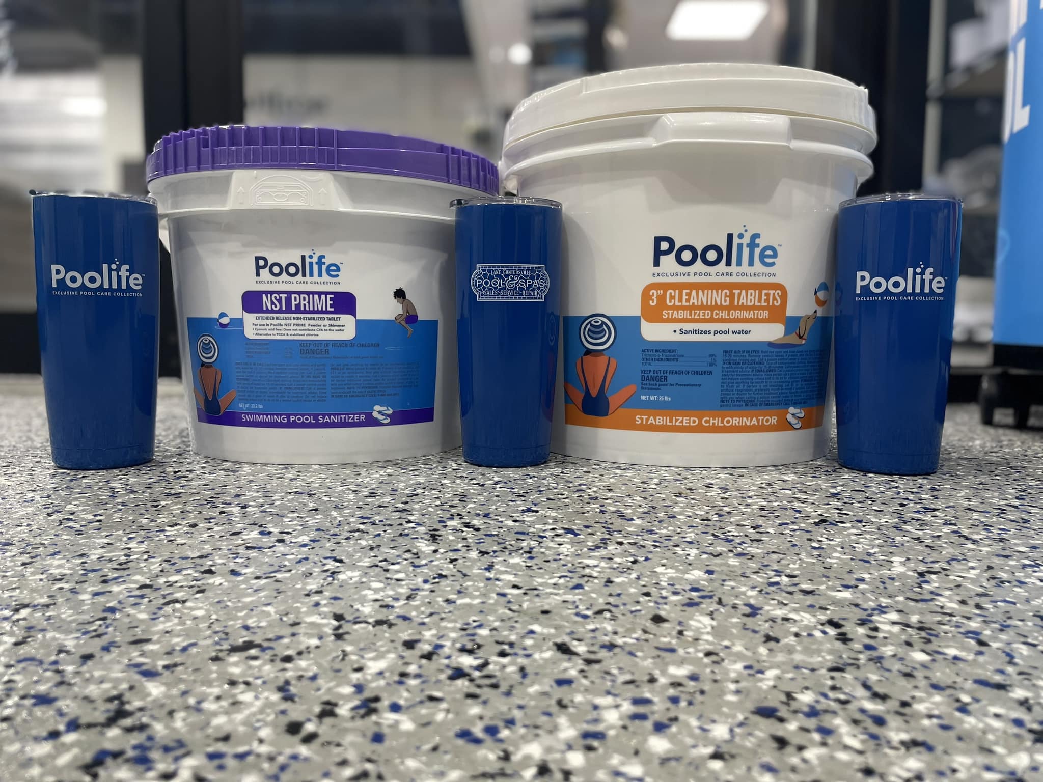 Poolife pool maintenance chemicals including NST Prime sanitizer and stabilized chlorinator tablets for backyard pools