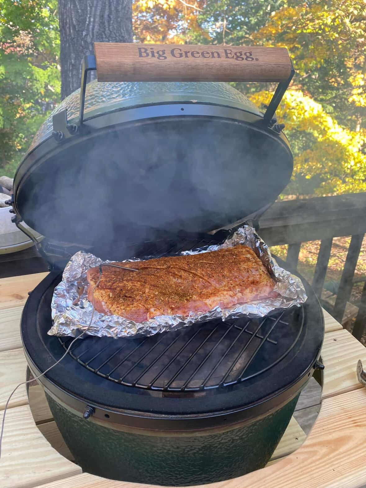 Smoked brisket wrapped in foil cooking on Big Green Egg outdoor grill