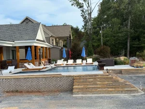 Luxury backyard pool and spa resort with lounge seating and residential hot tub installation